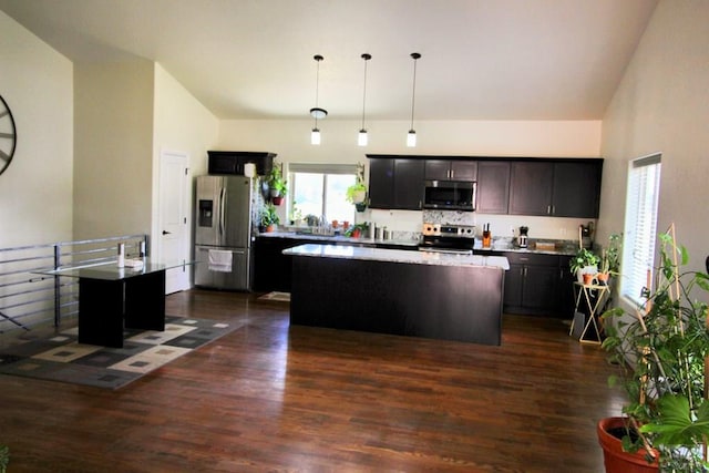 1470 Villa Spanada, Pueblo, CO 81006 - kitchen featuring stainless steel appliances, a kitchen island, dark wood-style floors, pendant lighting, and high vaulted ceiling