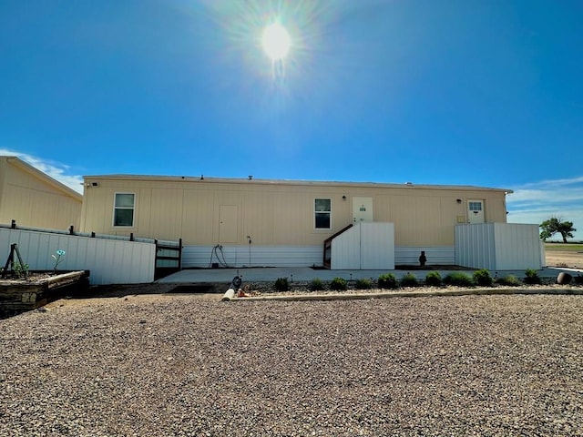 rear view of property with fence