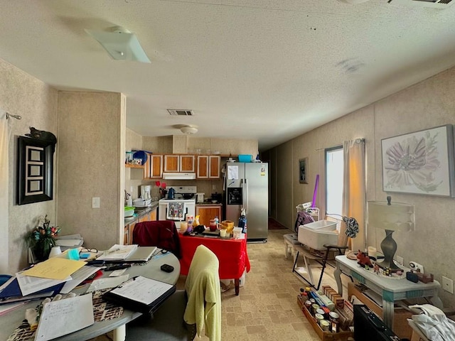 dining area featuring a textured ceiling and visible vents