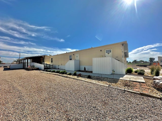 view of front of property with a patio area and fence