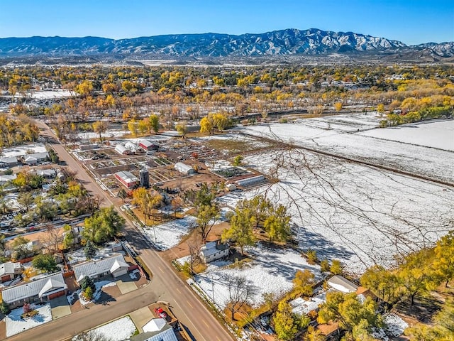 snowy aerial view featuring a residential view and a mountain view