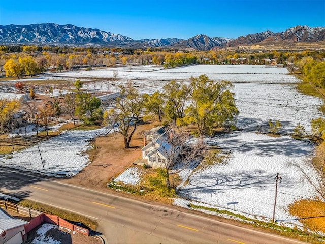 snowy aerial view featuring a mountain view