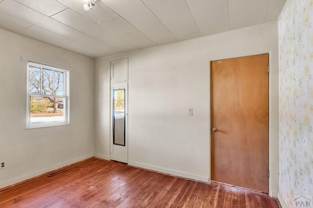 empty room with wood finished floors and baseboards