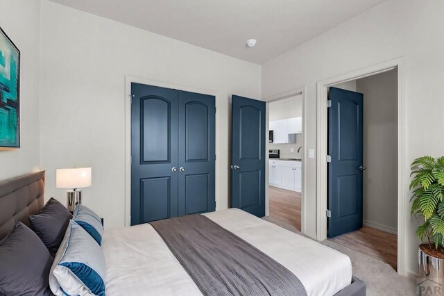 280 W Harmony Dr, Pueblo West, CO 81007 - bedroom featuring a closet, baseboards, and light wood-style flooring