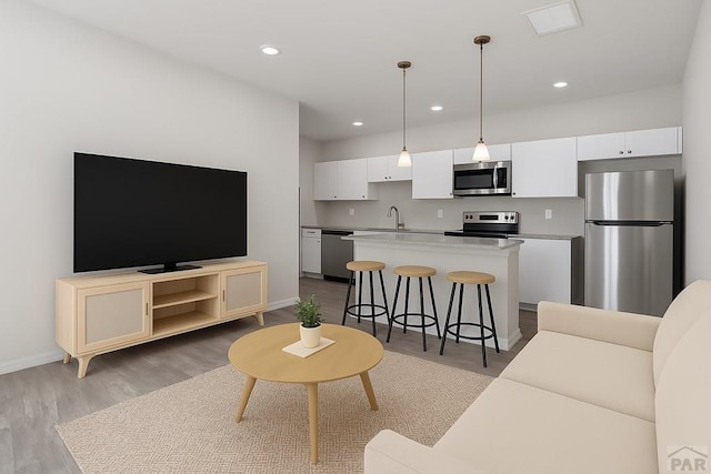 280 W Harmony Dr, Pueblo West, CO 81007 - living area featuring recessed lighting, baseboards, and wood finished floors