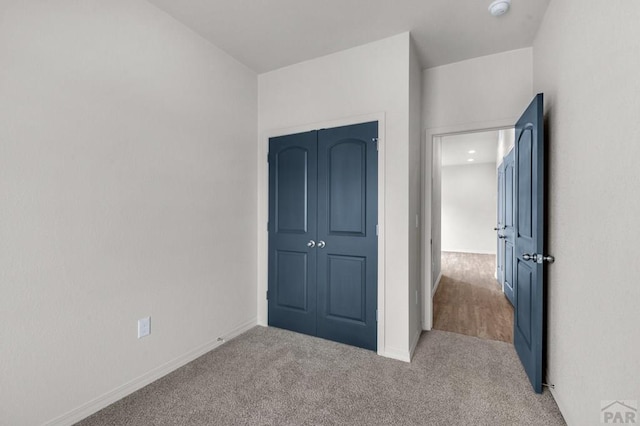 280 W Harmony Dr, Pueblo West, CO 81007 - unfurnished bedroom featuring a closet, carpet flooring, and baseboards