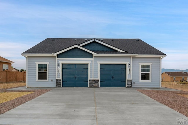 280 W Harmony Dr, Pueblo West, CO 81007 - view of front facade featuring fence, driveway, a shingled roof, and a garage