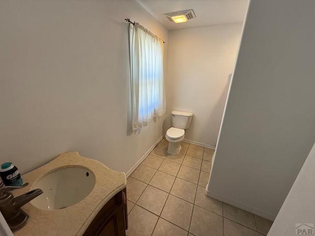 480 W 9th Ave, Lamar, CO 81073 - bathroom featuring tile patterned floors, toilet, vanity, and baseboards