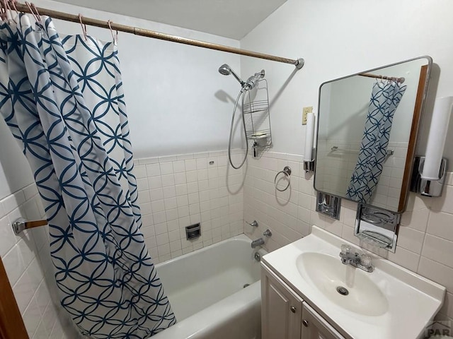 480 W 9th Ave, Lamar, CO 81073 - bathroom with tile walls, shower / bathtub combination with curtain, vanity, and a wainscoted wall