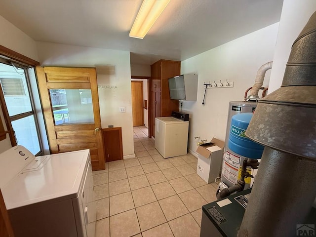 480 W 9th Ave, Lamar, CO 81073 - laundry area with separate washer and dryer, light tile patterned floors, water heater, and cabinet space