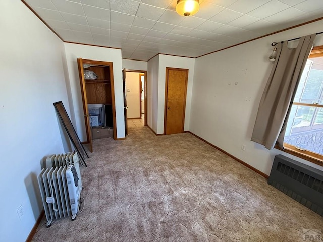 480 W 9th Ave, Lamar, CO 81073 - unfurnished bedroom with carpet floors, radiator, ornamental molding, and baseboards