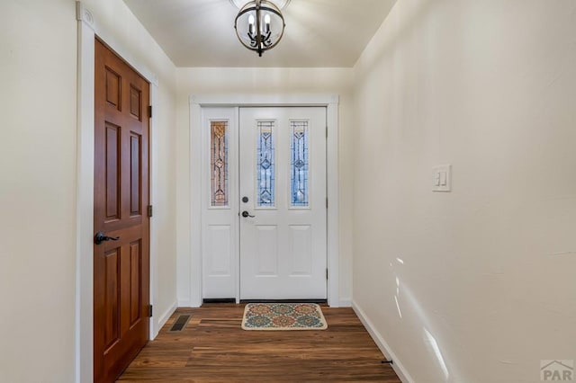 foyer entrance featuring dark wood-style floors and baseboards