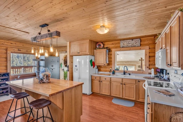 1918 Kelly Creek Trl, Canon City, CO 81212 - kitchen with white appliances, a sink, wooden ceiling, log walls, and a breakfast bar area