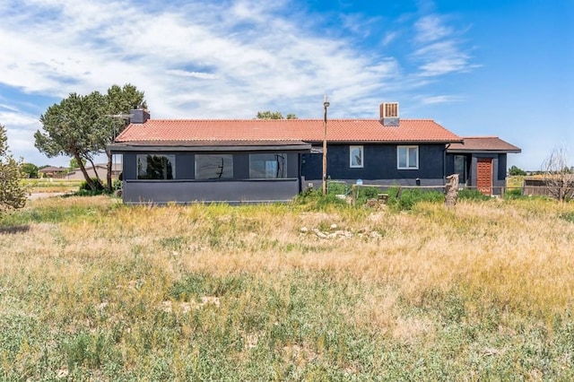 862 S Los Mochis Way, Pueblo, CO 81007 - back of property with a tiled roof and a chimney
