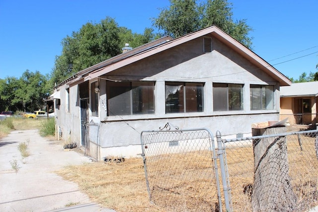 view of home's exterior featuring crawl space, fence, and stucco siding