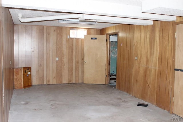 interior space featuring wooden walls, visible vents, and unfinished concrete floors