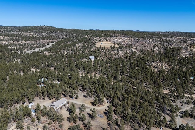 birds eye view of property with a forest view