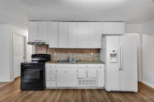 kitchen with white refrigerator with ice dispenser, black electric range oven, a sink, and white cabinets