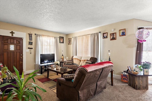 living area with carpet, baseboards, and a textured ceiling