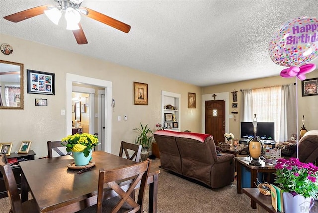 dining room with carpet floors and a textured ceiling