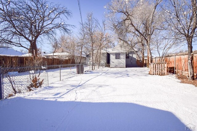 snowy yard with fence