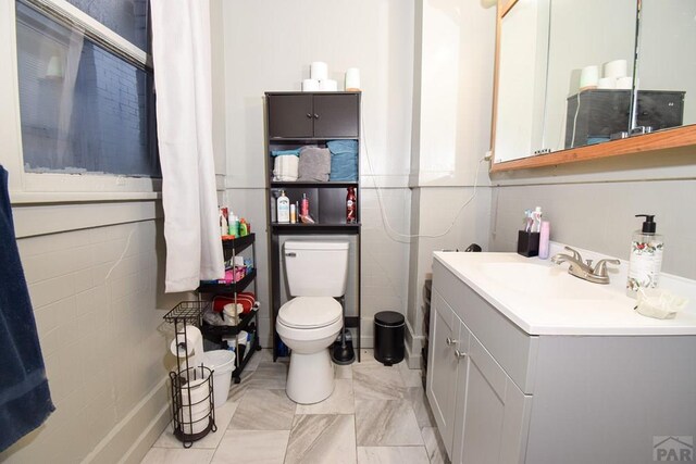 bathroom featuring vanity and toilet