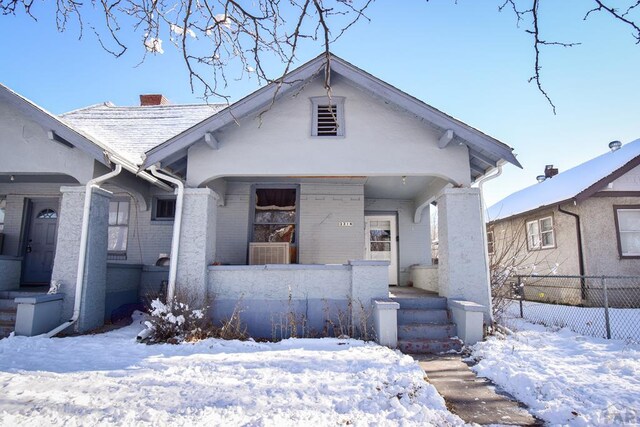 bungalow-style house with a porch and a chimney