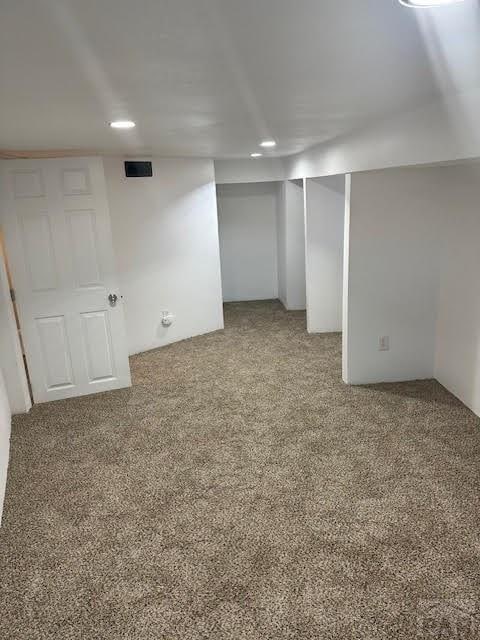 finished below grade area with carpet flooring and recessed lighting