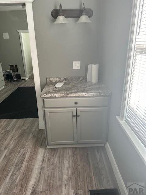 details featuring visible vents, baseboards, and wood finished floors