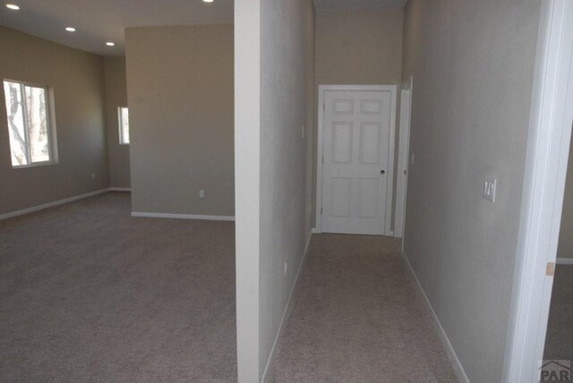 unfurnished living room featuring dark wood-type flooring, recessed lighting, and stairway