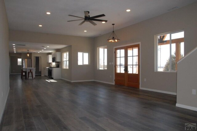 full bath featuring bathing tub / shower combination, recessed lighting, toilet, wood finished floors, and baseboards