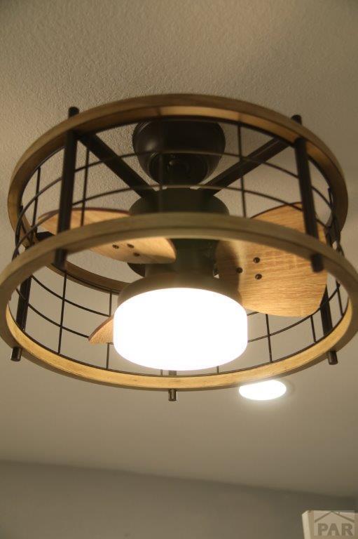 carpeted spare room featuring visible vents, a ceiling fan, and baseboards