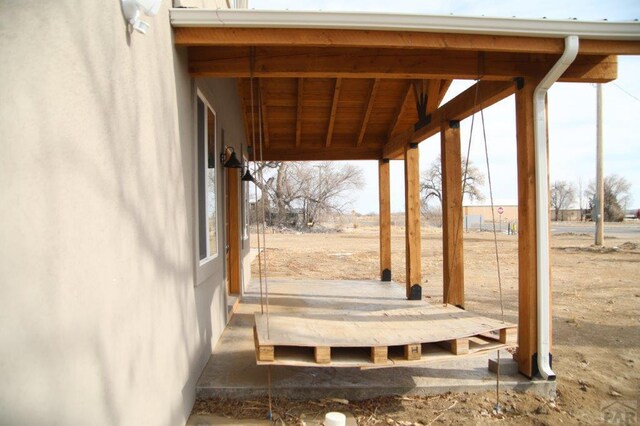 rear view of house with french doors and stucco siding