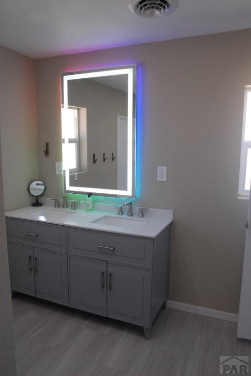 spare room with baseboards, dark wood finished floors, and recessed lighting