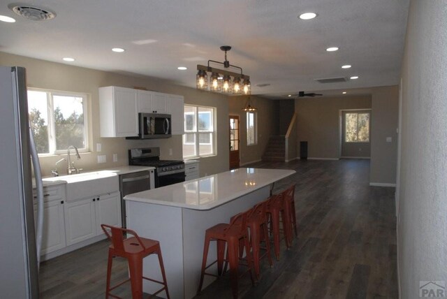 unfurnished bedroom featuring baseboards, a ceiling fan, visible vents, and light colored carpet