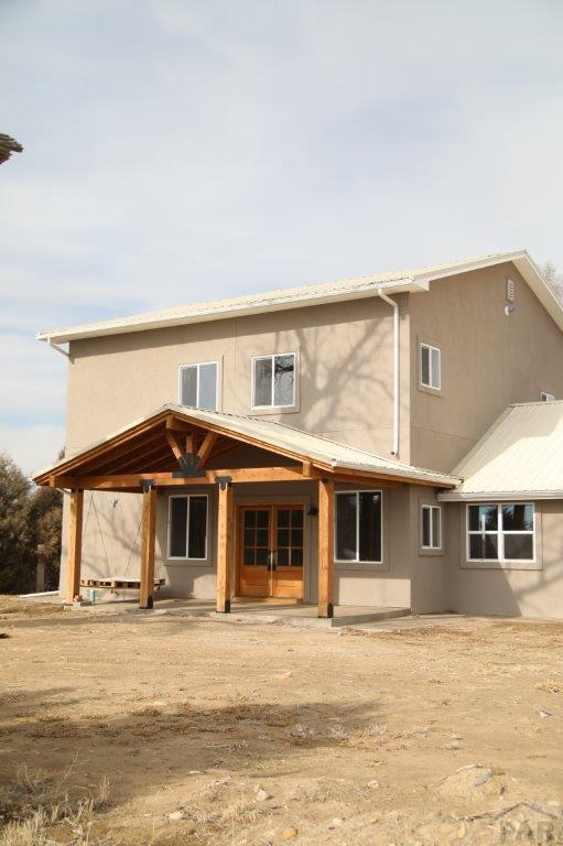 view of home's exterior with metal roof and stucco siding