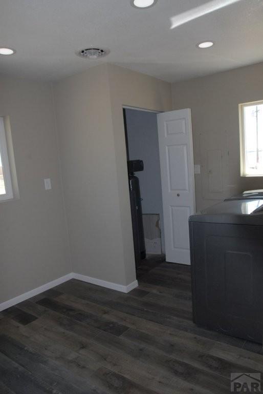 interior space with dark wood-type flooring, recessed lighting, baseboards, and stairs