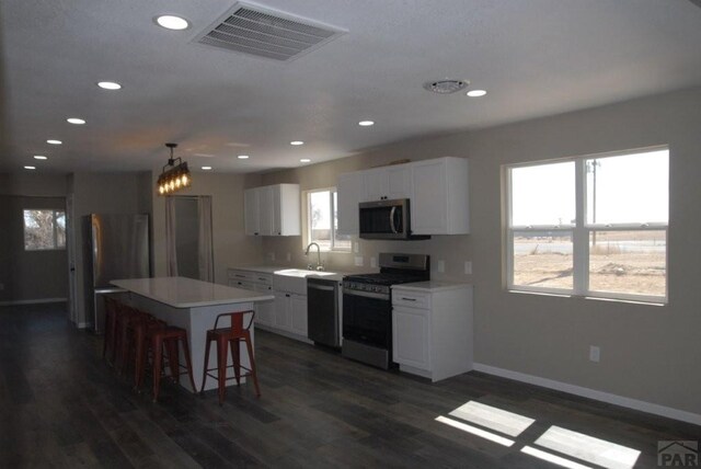 carpeted spare room featuring baseboards and a ceiling fan