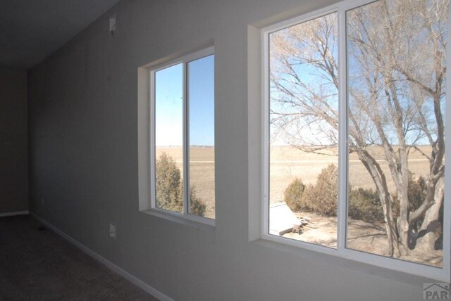 unfurnished room with dark wood-style floors and baseboards