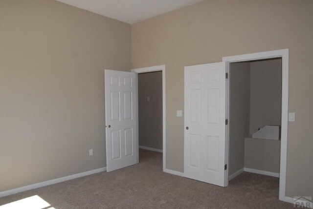 carpeted spare room with baseboards