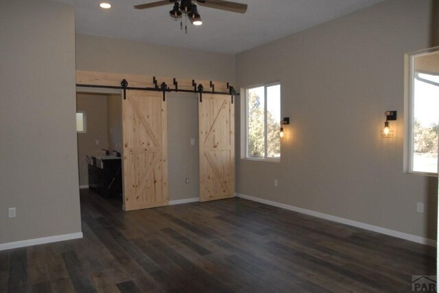 bathroom with baseboards, vanity, toilet, and wood finished floors