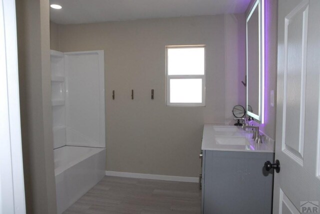 unfurnished living room with baseboards, dark wood finished floors, and recessed lighting