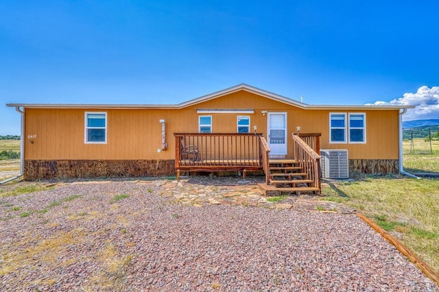 manufactured / mobile home featuring central air condition unit and a deck