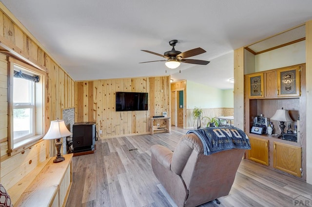 8417 3r Rd, Beulah, CO 80123 - living area featuring wood walls, light wood-style floors, a ceiling fan, and lofted ceiling