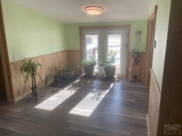 8417 3r Rd, Beulah, CO 80123 - dining area with wainscoting, french doors, wood finished floors, and wood walls