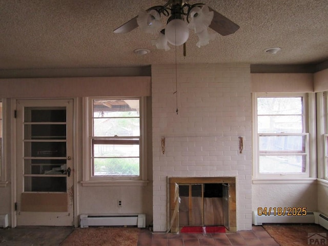 unfurnished living room with a baseboard heating unit, a ceiling fan, a textured ceiling, and a fireplace