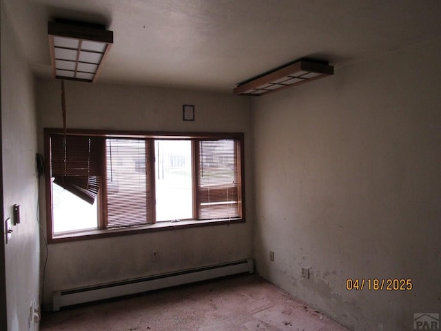 spare room with a baseboard heating unit
