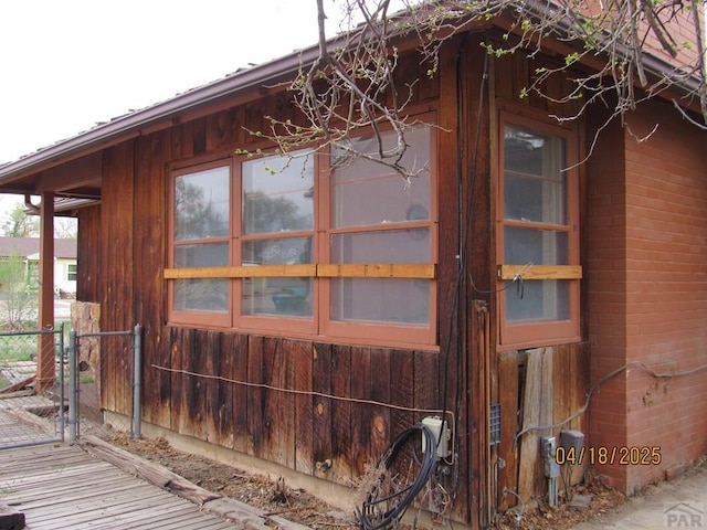 view of home's exterior featuring fence and brick siding