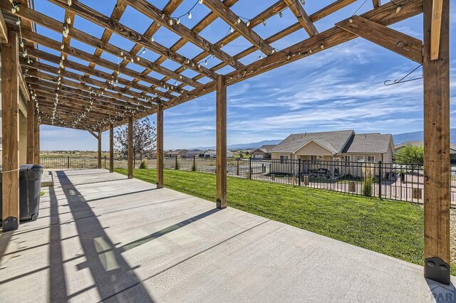 view of patio featuring fence and a pergola