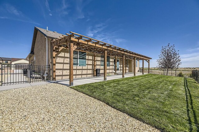 exterior space with a patio, a yard, fence, and stucco siding